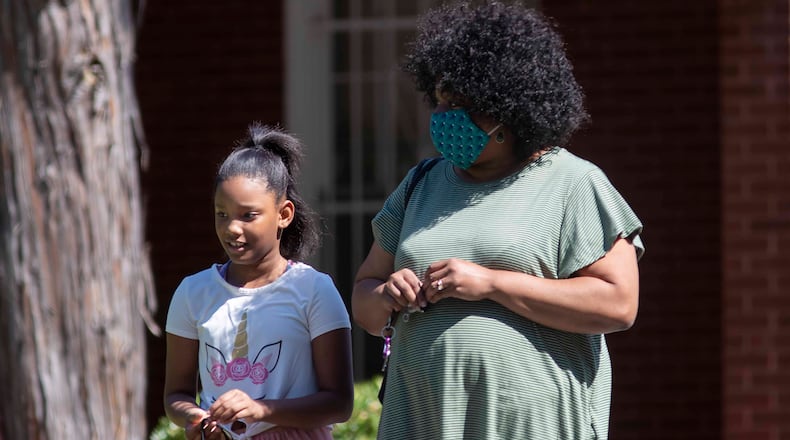07/14/2020 - Atlanta, Georgia - Sylena Battle, a student at KIPP Ways Primary School, left, exits Murray Brothers Funeral Home after paying her respects to her classmate, Secoriea Turner, during a public viewing in Atlanta, Tuesday, July 14, 2020. (ALYSSA POINTER / ALYSSA.POINTER@AJC.COM)