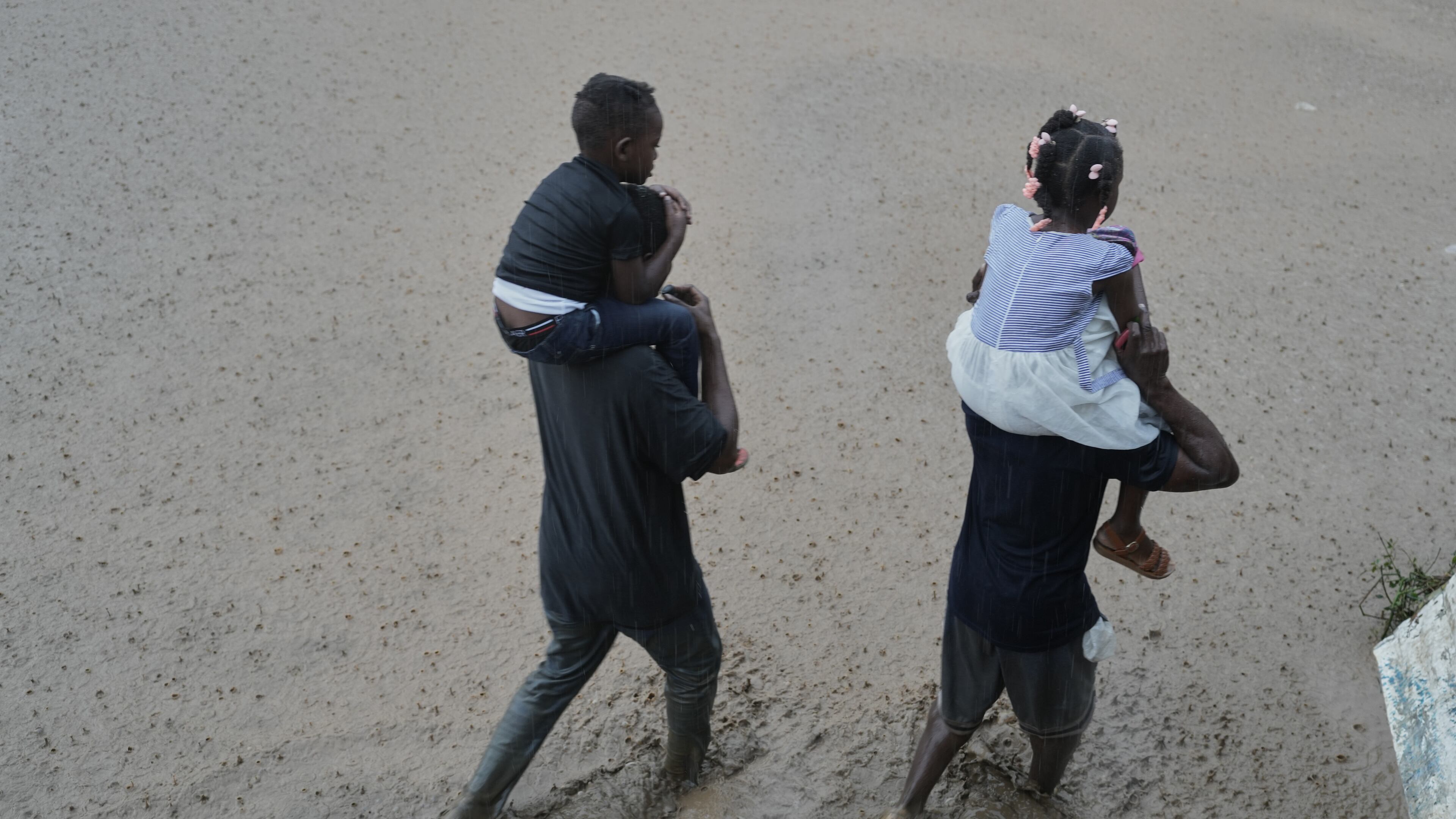 FILE - Residents wade through a flooded street in the aftermath of Hurricane Melissa in Petit-Goave, Haiti, Oct. 30, 2025. (AP Photo/Odelyn Joseph, File)