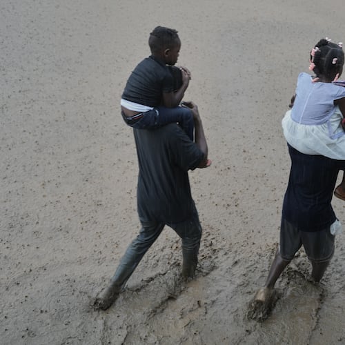 FILE - Residents wade through a flooded street in the aftermath of Hurricane Melissa in Petit-Goave, Haiti, Oct. 30, 2025. (AP Photo/Odelyn Joseph, File)