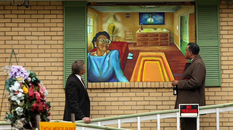 Gordon, left, and Motley admire a Janssen Robinson mural of Johnston painted on plywood over her boarded up home in the English Avenue community in 2008. CURTIS COMPTON / ccompton@ajc.com