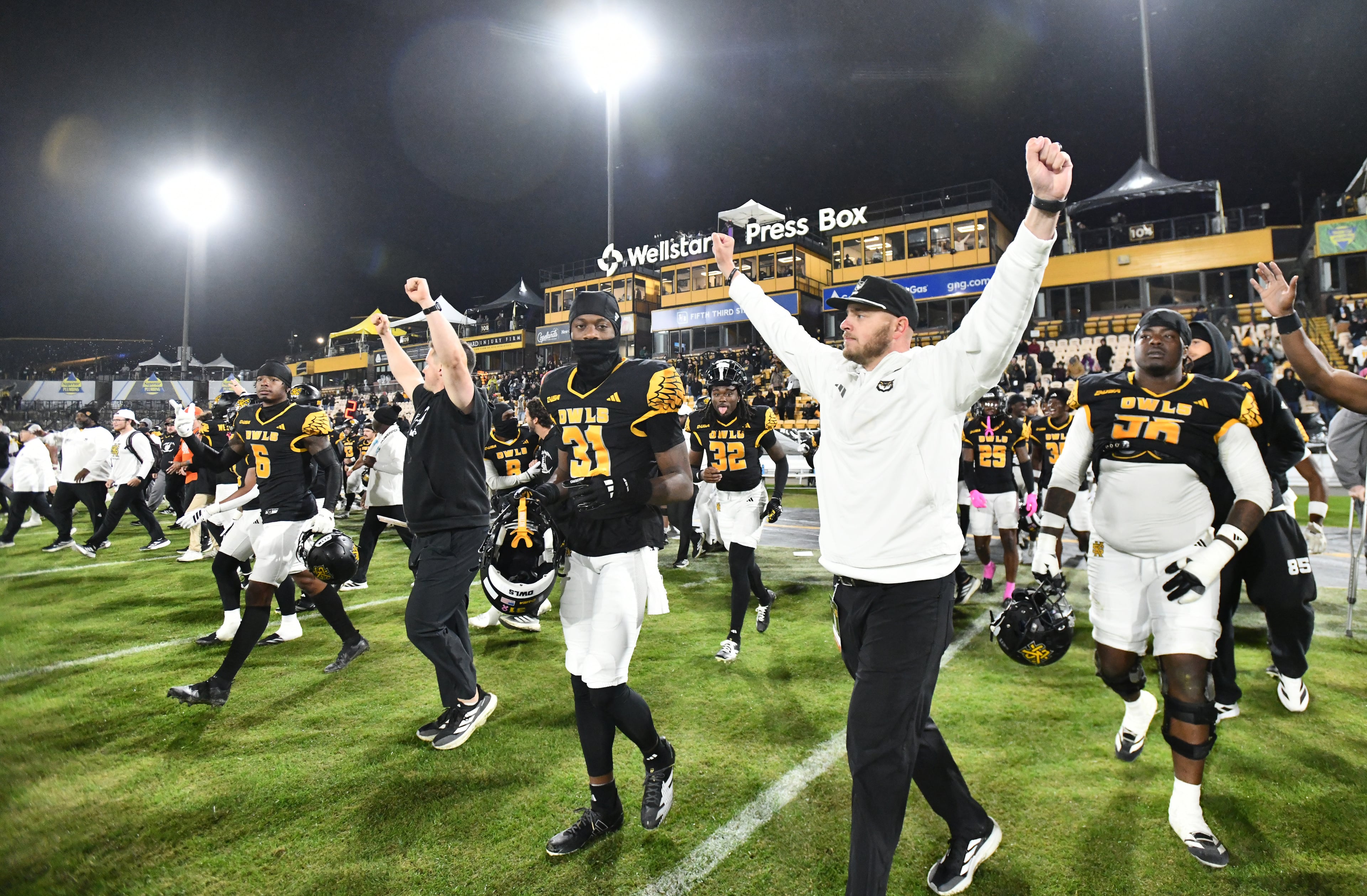 Kennesaw State players coaching staff celebrate after Kennesaw State beat UTEP during an NCAA college football game at Fifth Third Stadium, Tuesday, October 28, 2025 in Kennesaw. Kennesaw State won 33-20 over University of Texas at El Paso. (Hyosub Shin / AJC)