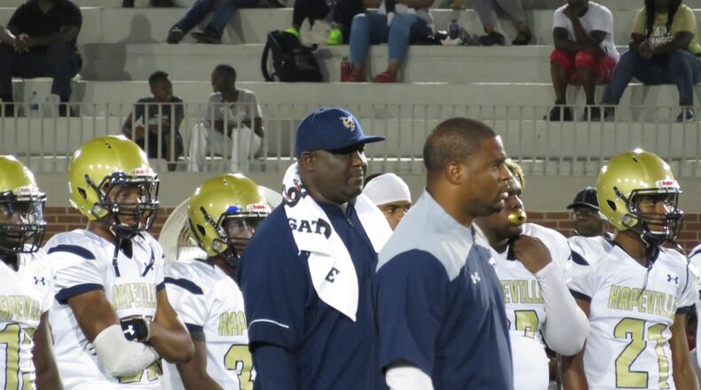 Winston Gordon (center, hat) has coached the Hornets since the program's inaugural season in 2011. (Adam Krohn)