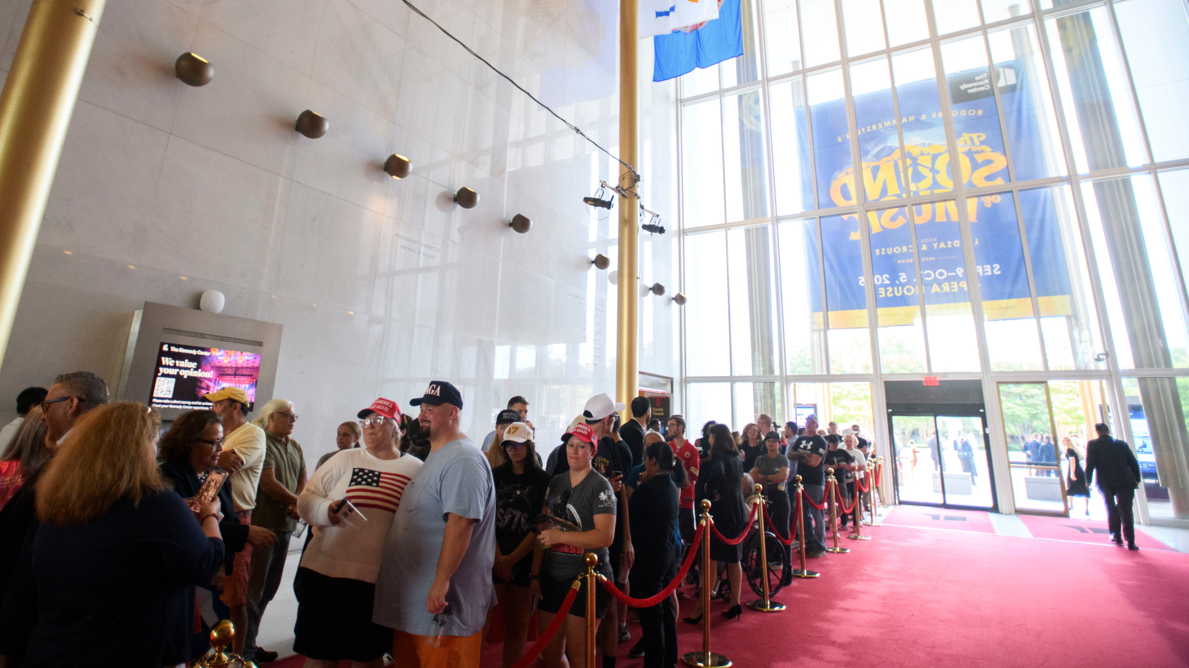 People wait in line for a memorial and prayer vigil for Charlie Kirk at the John F. Kennedy Memorial Center for the Performing Arts, Sunday, Sept. 14, 2025, in Washington. (AP Photo/Rod Lamkey, Jr.)