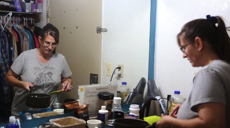 Rimbey Schroeder, 44, cooks lunch for her three daughters at the Motel 6 in Norcross, where they have lived for nearly a year. After an AJC article mentioning the family, there have been offers of help, and there is hope that the family’s situation will change soon. CHRISTINA MATACOTTA / CHRISTINA.MATACOTTA@AJC.COM
