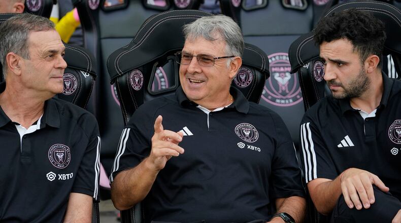 Inter Miami head coach Gerardo "Tata" Martino speaks to members of his staff before the first half of a Leagues Cup soccer match against Atlanta United, Tuesday, July 25, 2023, in Fort Lauderdale, Fla. (AP Photo/Lynne Sladky)