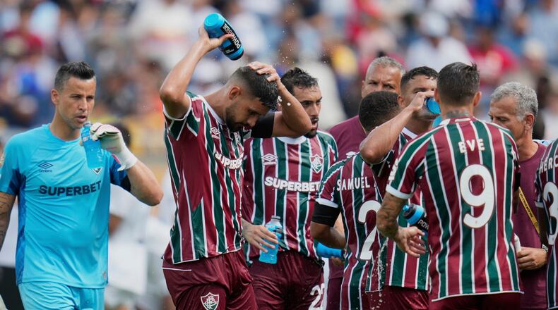 FILE - Fluminense players cooling up during a water break at the Club World Cup quarterfinal soccer match between Fluminense and Al Hilal in Orlando, Fla., Friday, July 4, 2025. (AP Photo/John Raoux, file)