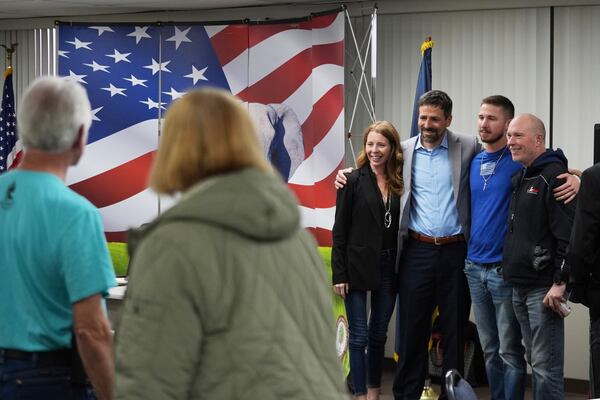 Ryan Kelley, third from right, poses for photos after his talk at the Jackson County Republican headquarters, Thursday, April 10, 2025, in Jackson, Mich. (AP Photo/Paul Sancya)