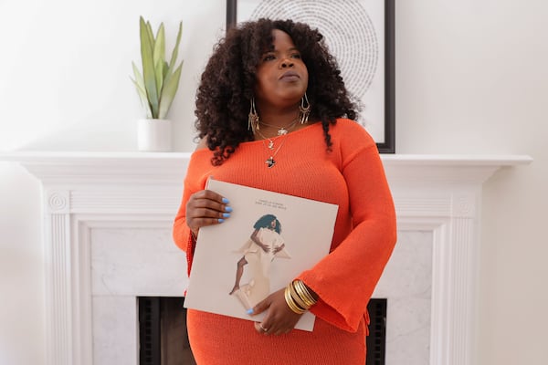 Danielle Ponder holds a vinyl copy of her first album at her home in Stone Mountain on June 6, 2025. The singer quit her job as a public defender in Rochester, New York, to pursue a music career in Atlanta. (Natrice Miller/AJC)