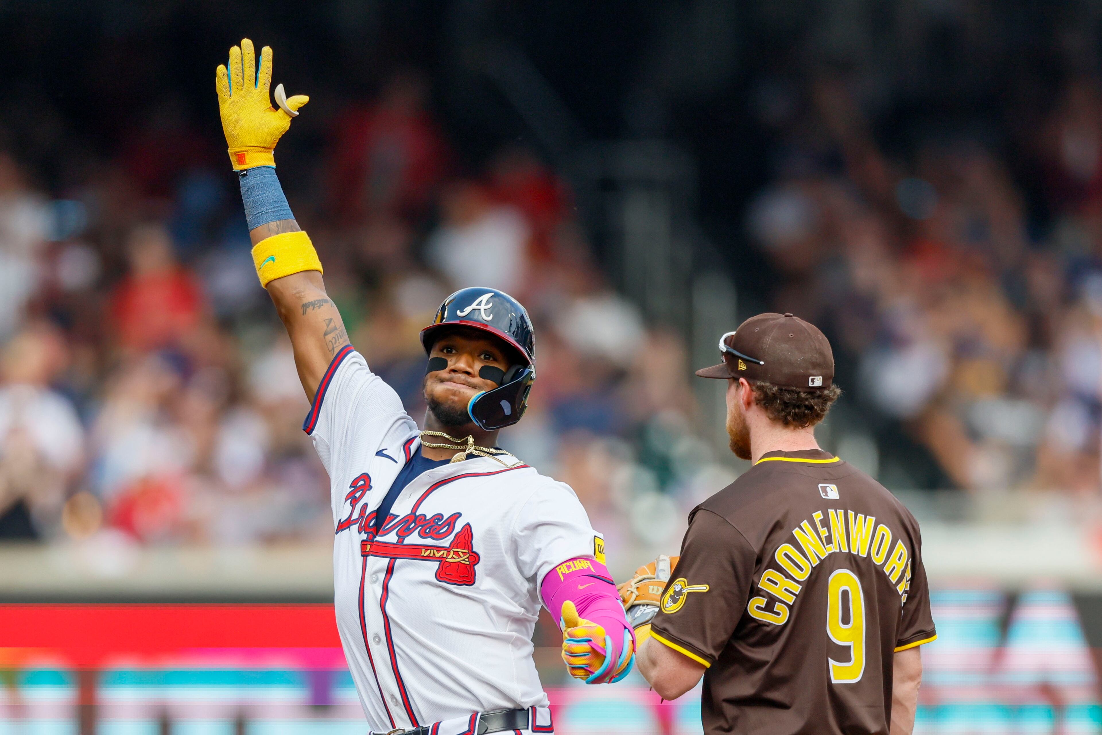 Atlanta Braves' Ronald Acuña Jr. (13) reacts with teammates after hitting a double during the fifth inning of a baseball game against the San Diego Padres on Sunday, May 25, 2025, in Atlanta. (Miguel Martinez/Atlanta Journal-Constitution via AP)