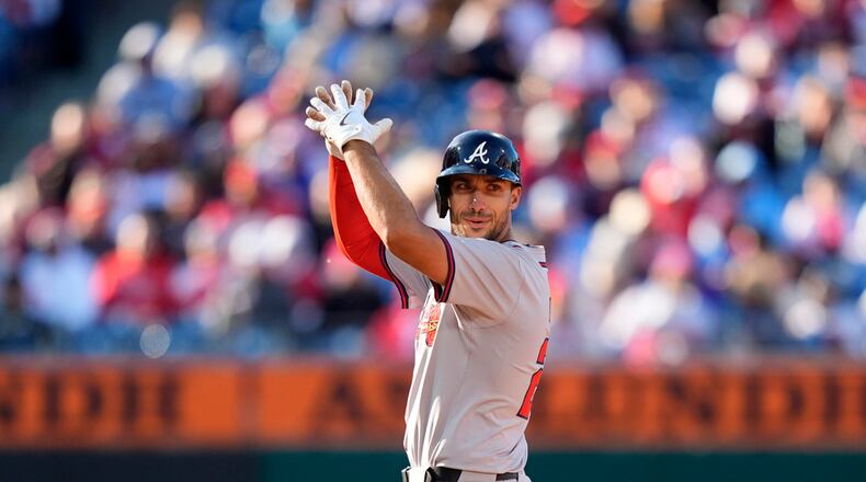 Atlanta Braves' Matt Olson reacts after hitting a three-run double against Philadelphia Phillies pitcher Connor Brogdon during the eighth inning of an opening-day baseball game, Friday, March 29, 2024, in Philadelphia. (AP Photo/Matt Slocum)