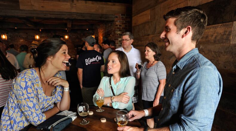 Beer aficionados Molly Heacock, Andriennne Young, and Taylor Brown enjoy a beer at Three Taverns Craft Brewery. David Tulis / AJC Special