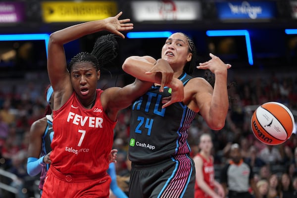 Indiana Fever's Aliyah Boston (7) and Atlanta Dream's Brionna Jones battle for a loose ball during the second half of a WNBA basketball game, Friday, July 11, 2025, in Indianapolis. (AP Photo/AJ Mast)
