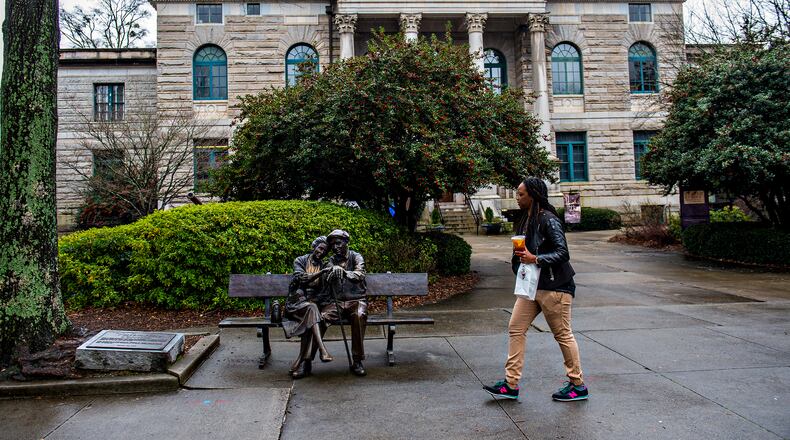 Kymoura Kennedy walks past the historic courthouse in downtown Decatur on Feb. 23, 2016. JONATHAN PHILLIPS / SPECIAL