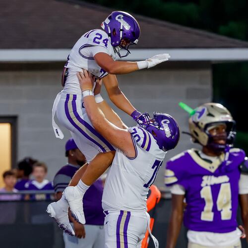 Carterville tight end Cole Crawford (left) celebrates his touchdown against Hiram with offensive lineman Carter Levstek on Friday, Aug. 21, 2026, in Hiram. (Erik S. Lesser for the AJC)