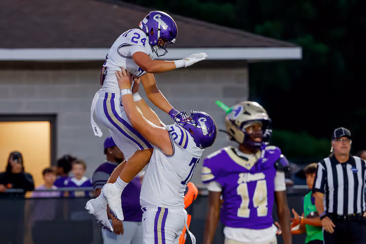 Carterville tight end Cole Crawford (left) celebrates his touchdown against Hiram with offensive lineman Carter Levstek on Friday, Aug. 21, 2026, in Hiram. (Erik S. Lesser for the AJC)