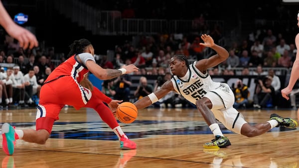Michigan State forward Coen Carr (55) and Mississippi guard Dre Davis (14) vie for a loose ball during the first half in the Sweet 16 of the NCAA college basketball tournament, Friday, March 28, 2025, in Atlanta. (AP Photo/Brynn Anderson)
