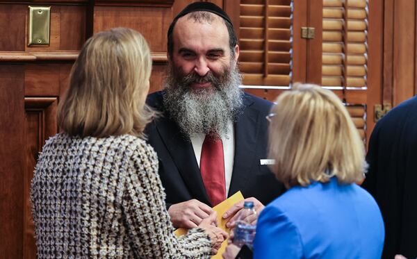 Rabbi Hirshy Minkowicz of North Fulton Chabad chats with House legislators on day 38 of the Georgia Legislative session on Wednesday, April 2, 2025. (Natrice Miller/ AJC)