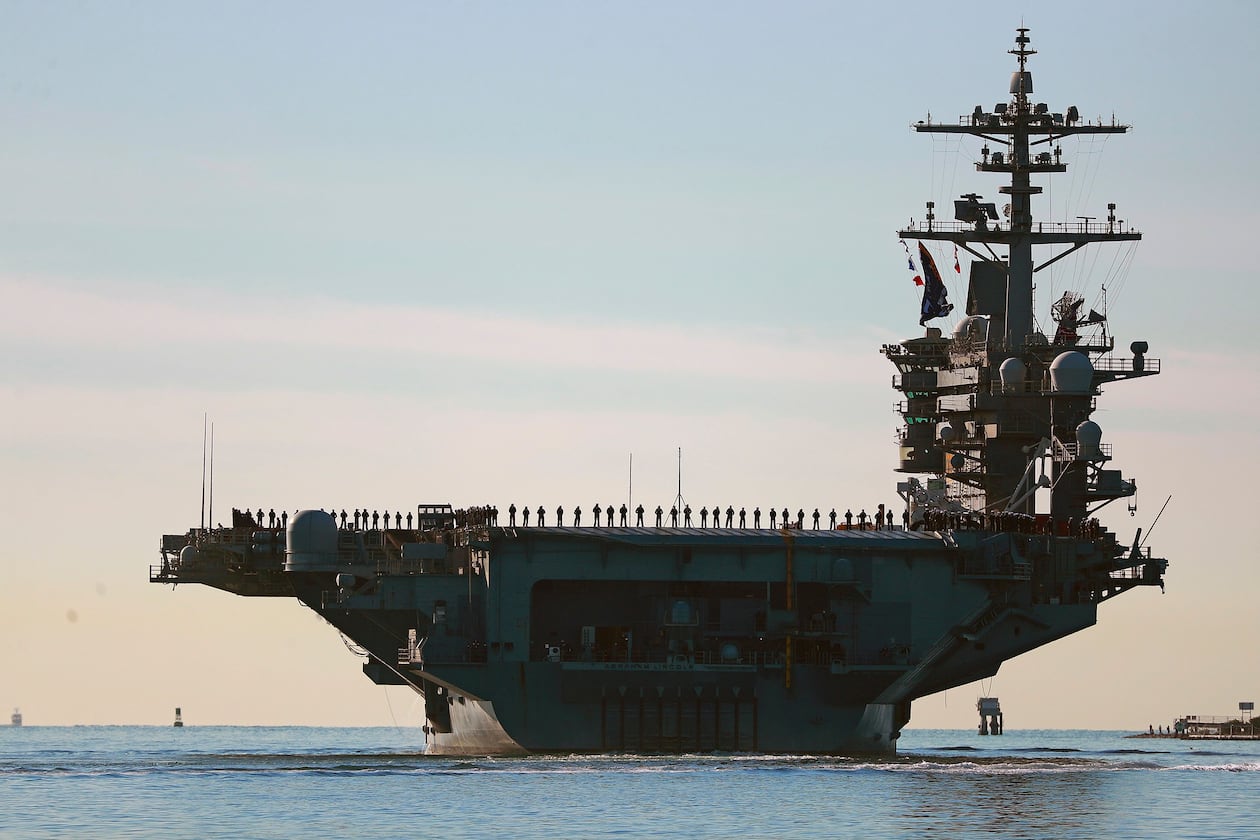 Sailors and Marines line the deck of aircraft carrier USS Abraham Lincoln (CVN-72) as it deploys from San Diego, Jan. 3, 2021. (K.C. Alfred/The San Diego Union-Tribune via AP, File)