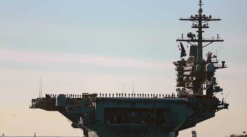 Sailors and Marines line the deck of aircraft carrier USS Abraham Lincoln (CVN-72) as it deploys from San Diego, Jan. 3, 2021. (K.C. Alfred/The San Diego Union-Tribune via AP, File)