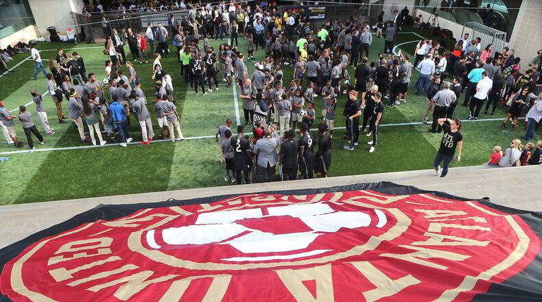 Participants cover the field during the opening of the 9,600-square foot mini-pitch at the Five Points MARTA station on Thursday. Curtis Compton /ccompton@ajc.com