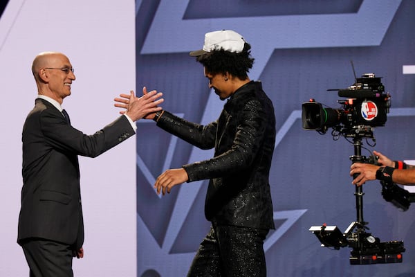 Dylan Harper greets NBA commissioner Adam Silver after being selected second by the San Antonio Spurs In the first round of the NBA basketball draft, Wednesday, June 25, 2025, in New York. (AP Photo/Adam Hunger)