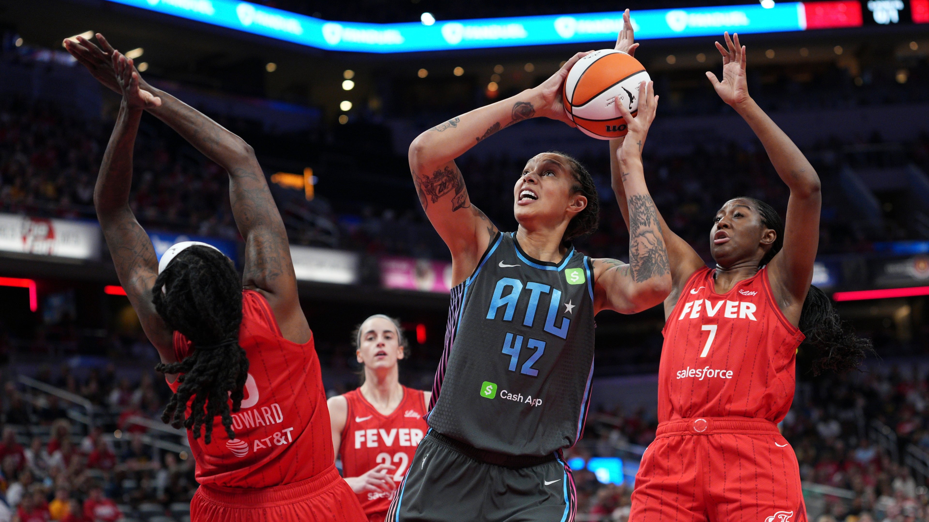 Atlanta Dream's Brittney Griner (42) shoots against Indiana Fever's Natasha Howard (6) and Aliyah Boston (7) during the first half of a WNBA basketball game, Friday, July 11, 2025, in Indianapolis. (AP Photo/AJ Mast)