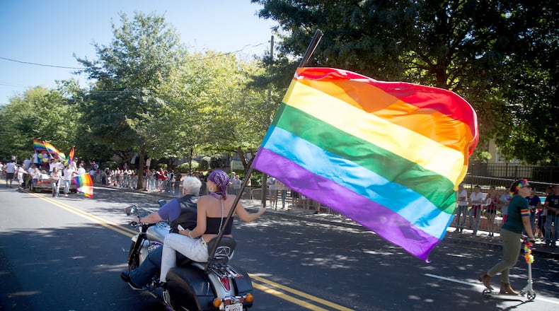 A motorcycle with a large rainbow flag heads up 10th Street during the Atlanta Pride Parade in this October 2016 file photo.