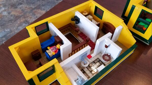 In this Dec. 12, 2017 photo provided by WSTM-TV, an interior view of a model of the house from "A Christmas Story" rests on a floor in Jason Middaugh's Marcellus, N.Y. home. WSTM-TV in Syracuse reports Middaugh's small family project to recreate the house from the classic holiday film turned into a six-month undertaking. He says he and his family scoured the internet to find the 2,000 pieces needed to construct the home. Lego reviews set proposals when 10,000 people support a project on their special site. The Middaugh family's set has received nearly 9,000 endorsements.  (WSTM-TV via AP)