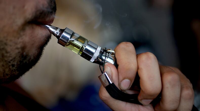 The city of Marietta will consider banning the use of e-cigarettes at its parks and along sidewalks.