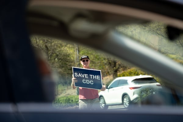 John Aberle-Grasse, who retired after 23 years at the Centers For Disease Control and Prevention and whose daughter currently works for them, protests outside of the CDC headquarters in Atlanta on Friday, March 28, 2025 (Ben Gray for the Atlanta Journal-Constitution)