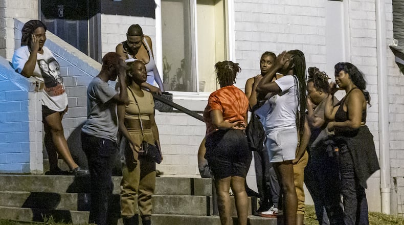 Family and friends gathered near the spot where two teenagers were killed in a shooting outside a southwest Atlanta apartment complex shortly after midnight on July 2.