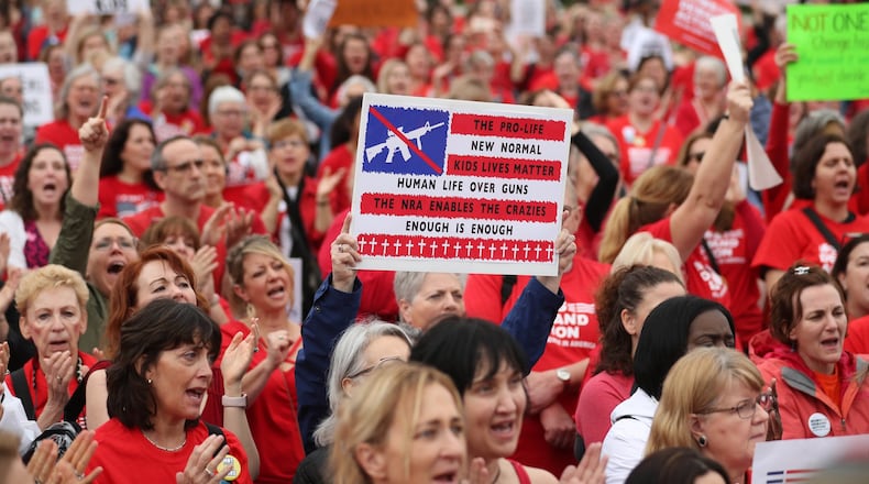 A protester holds a sign during the Moms Demand Action Advocacy Day rally at Liberty Plaza Wednesday, Feb. 21, 2018, in Atlanta, lobbying for stricter gun laws. PHOTO / JASON GETZ