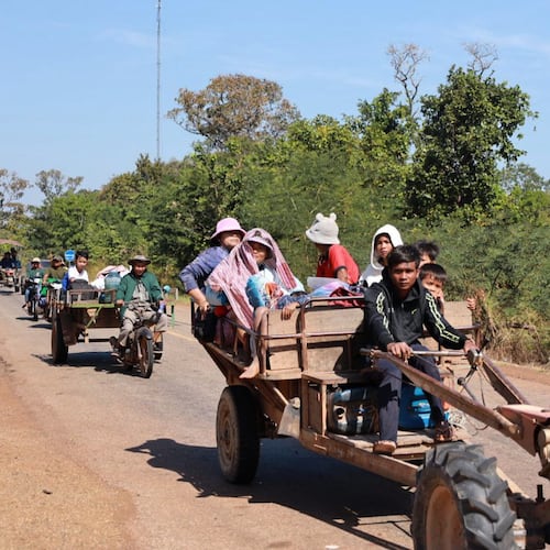 In this photo released by Agence Kampuchea Press (AKP), Cambodian villagers sit on tractors as they flee from the home in Preah Vihear province, Cambodia, Monday, Dec. 8, 2025. (AKP via AP)