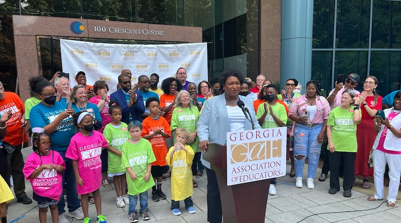 Stacey Abrams announces a plan to hike teacher pay outside the Georgia Association of Educators headquarters. Photo/Greg Bluestein
