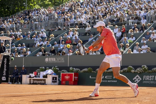 Novak Djokovic of Serbia returns a ball to Hubert Hurkacz of Poland during their final match of the ATP 250 Geneva Open tennis, in Geneva, Switzerland, Saturday, May 24, 2025. (Martial Trezzini/Keystone via AP)