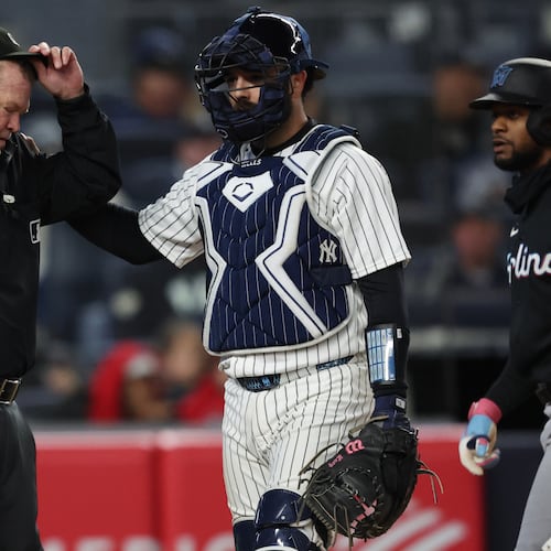New York Yankees catcher Austin Wells (28) checks on home plate umpire Ron Kulpa during the fourth inning of a baseball game against the Miami Marlins, Saturday, April 4, 2026, in New York. (AP Photo/Heather Khalifa)