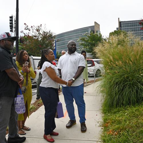 Family members visit a memorial plaque installed in honor of DeKalb County Police Officer David Rose outside the Centers for Disease Control and Prevention in Atlanta on Friday, Aug. 7, 2026. U.S. Secretary of Health and Human Services Secretary Robert F. Kennedy Jr. visited the CDC Friday to mark the one-year anniversary of the shooting that killed Rose. (Hyosub Shin/AJC)