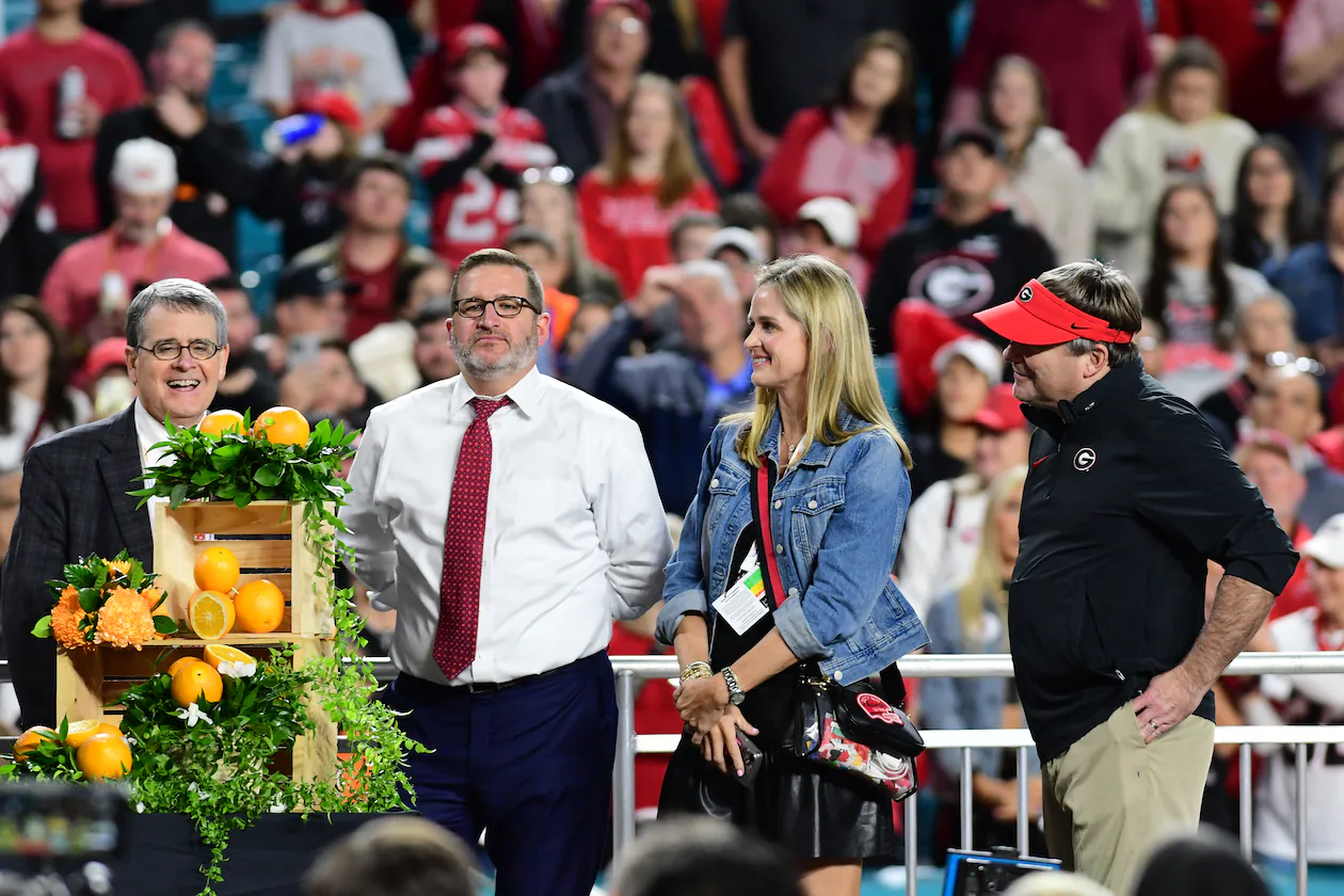 (From left): Jere Morehead, Josh Brooks, Mary Beth Smart and Kirby Smart take part in the trophy presentation following the 90th Orange Bowl game between Georgia and Florida State at Hard Rock Stadium inn Miami Gardens, Florida. (Perry McIntyre/UGA Sports Communications 2023)