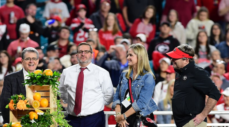 (From left): Jere Morehead, Josh Brooks, Mary Beth Smart and Kirby Smart take part in the trophy presentation following the 90th Orange Bowl game between Georgia and Florida State at Hard Rock Stadium inn Miami Gardens, Florida. (Perry McIntyre/UGA Sports Communications 2023)