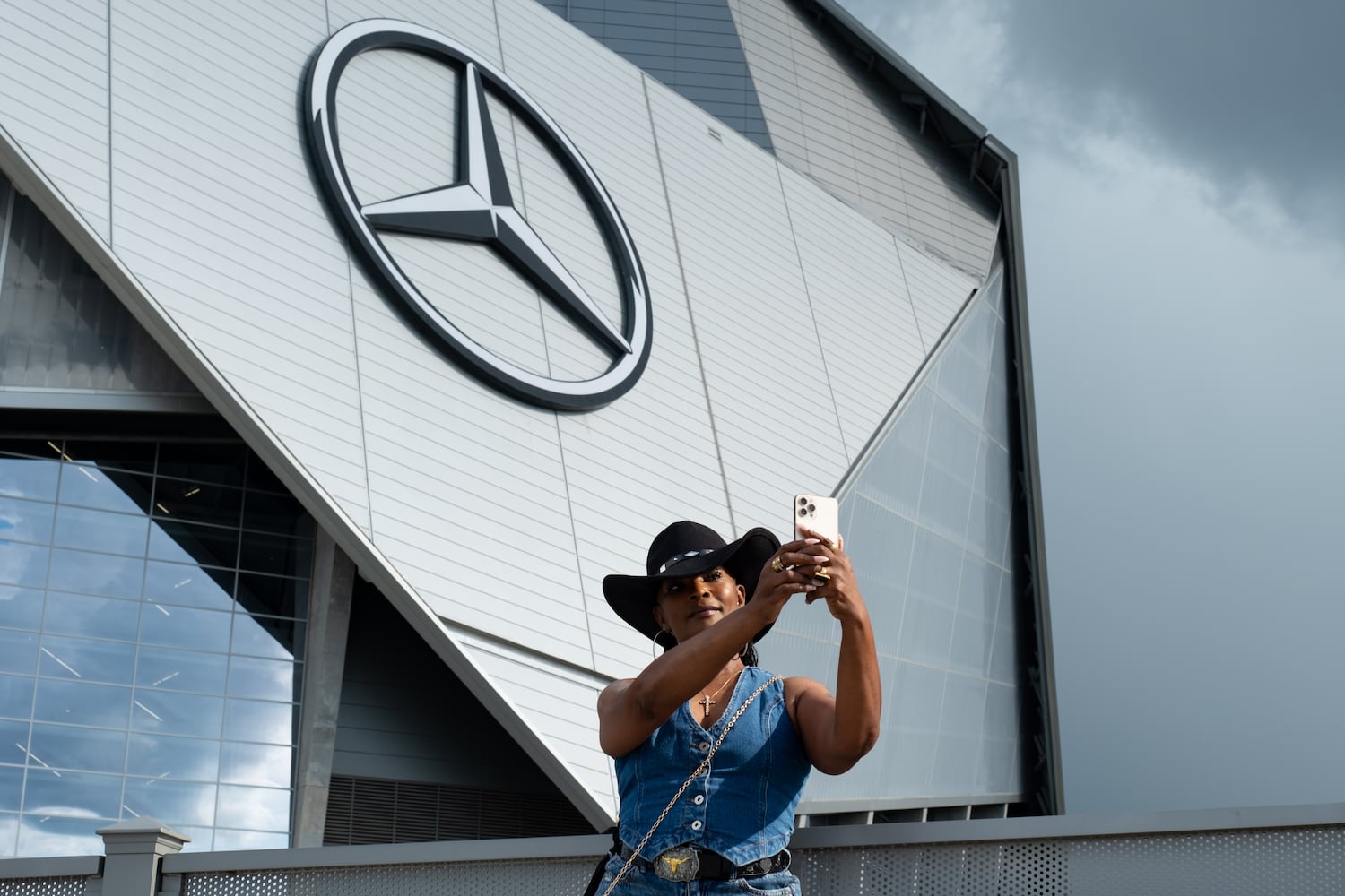 DanElla Smith shoots a selfie in front of Mercedes-Benz Stadium before going in for Beyoncè’s “Cowboy Carter” show Friday, July 11, 2025.   Ben Gray for the Atlanta Journal-Constitution