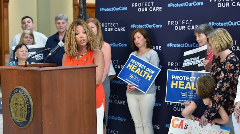 August 23, 2019 Atlanta - U.S. Representative Lucy McBath speaks as Vivienne Sacks (right), 5, holds a sign during “Protect Our Care Georgia Health Care Emergency” Press Conference at the Georgia State Capitol on Friday, August 23, 2019. Protect Our Care “Health Care Emergency” Bus Tour Continues With Stops in Maine, New Hampshire, North Carolina and Georgia. (Hyosub Shin / Hyosub.Shin@ajc.com)