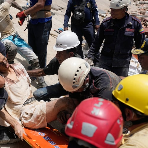 Rescue workers place Daniel Cordero on a stretcher after pulling him from the rubble two days after an earthquake struck Catia la Mar, Venezuela, Friday, June 26, 2026. (AP Photo/Fernando Vergara)