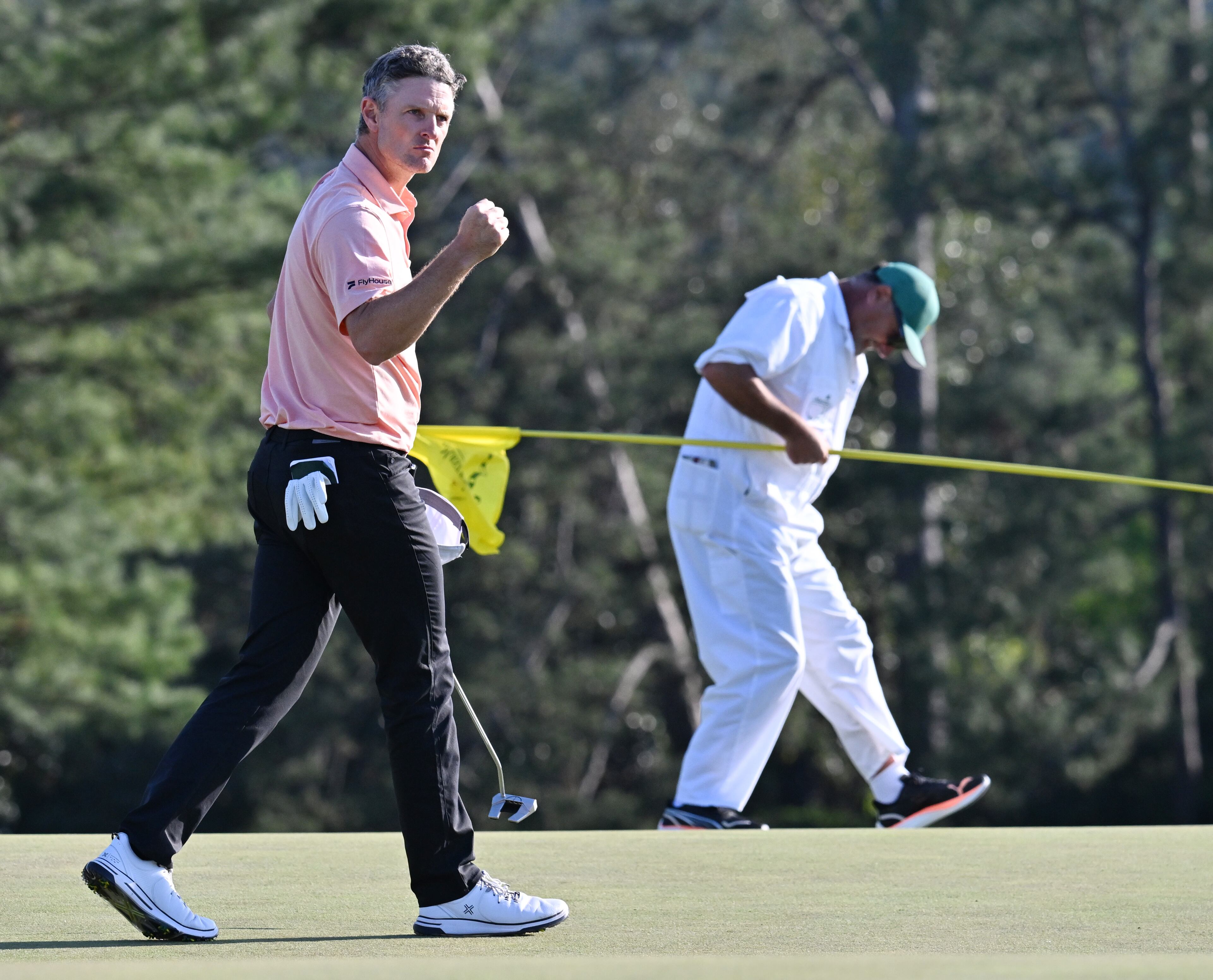 Justin Rose and his caddie Mark Fulcher celebrate his birdie putt on 18th hole during final round of the Masters golf tournament, at Augusta National Golf Club, Sunday, April 13, 2025, in Augusta, Ga. (Hyosub Shin / AJC)