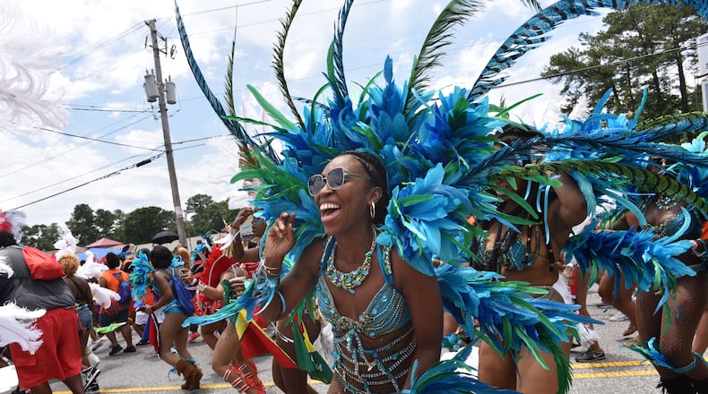 May 27, 2017 Decatur - Parade participants march down Covington Highway during Atlanta Caribbean Carnival Parade in Decatur on Saturday, May 27, 2017. The parade is hosted by Atlanta Carnival Bandleaders Council (ACBC) to promote a broader understanding and a deeper appreciation of Caribbean culture among the Atlanta community by seeking the interest of carnival bands and steel bands, and using the Atlanta Caribbean Carnival as a vehicle for the promotion of Caribbean culture. HYOSUB SHIN / HSHIN@AJC.COM
