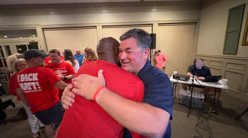 Houston County sheriff's Lt. Matt Moulton, right, hugs, sheriff's Maj. Tommy Jackson on Tuesday, May 21, 2024 after Moulton won the county's Republican primary in his bid to succeed longtime Sheriff Cullen Talton. (Joe Kovac / AJC)