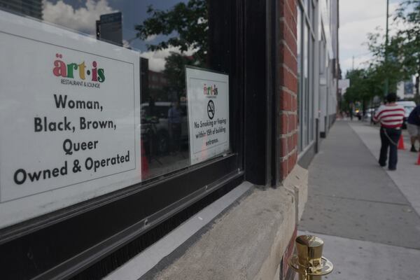 People walk by Artis Restaurant and Lounge in Chicago on Thursday, July 3, 2025. (AP Photo/Laura Bargfeld)