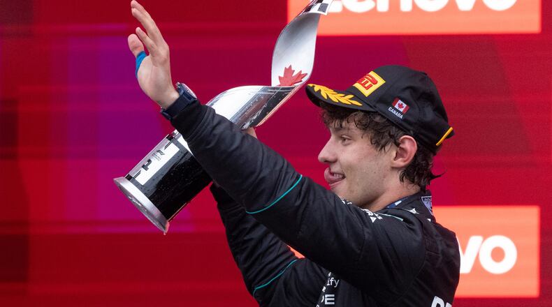 Mercedes driver Kimi Antonelli, of Italy, waves as he holds his trophy following his win in the F1 Canadian Grand Prix auto race in Montreal, Sunday, May 24, 2026. (Christinne Muschi/The Canadian Press via AP)