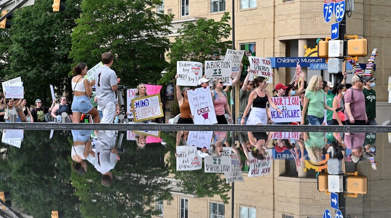 People march through Centennial Olympic Park to protest the Supreme Court's decision to overturn Roe v. Wade in downtown Atlanta on Saturday, June 25, 2022. (Hyosub Shin / Hyosub.Shin@ajc.com)