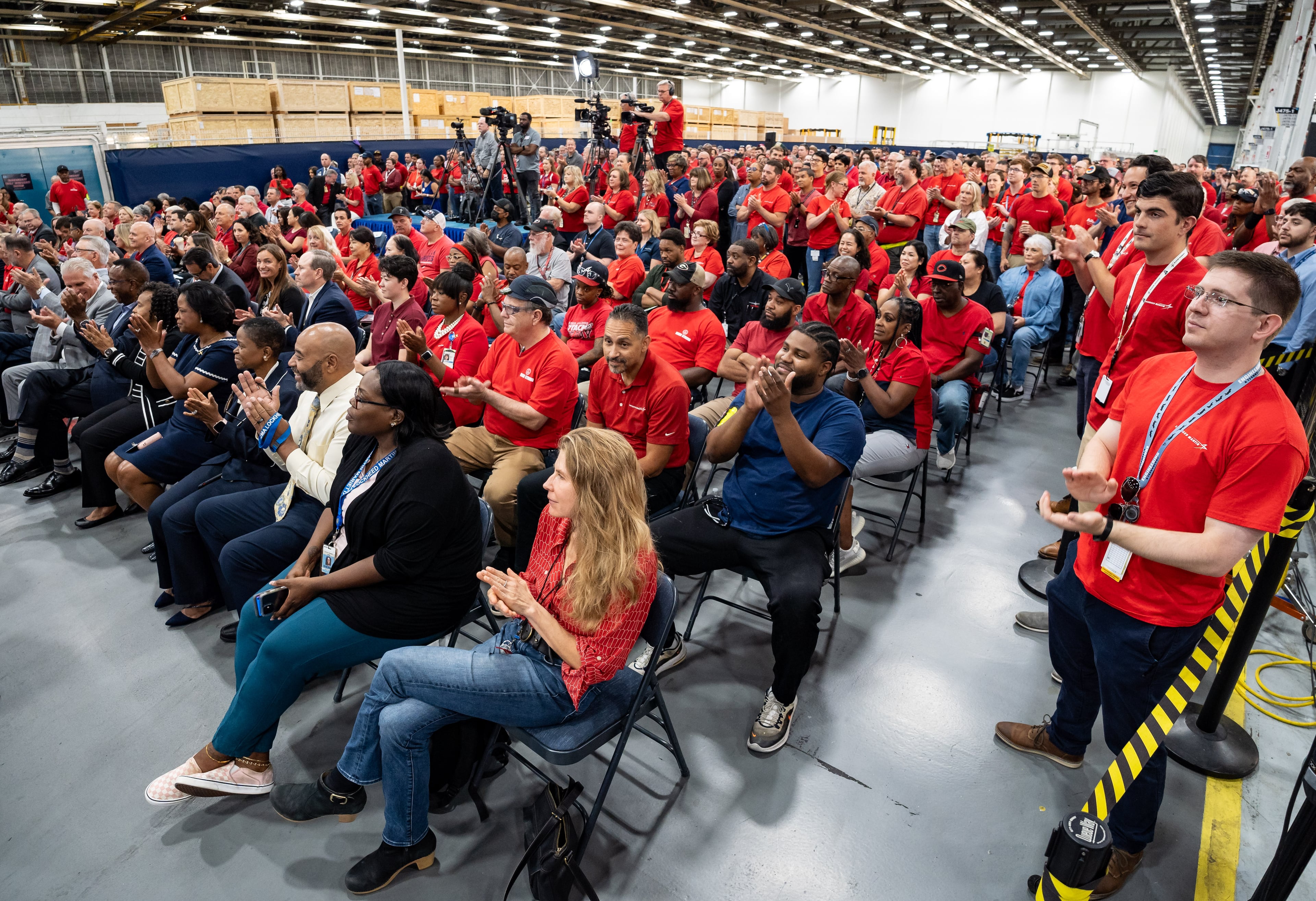 Employees clap during a presentation about the C130J cargo aircraft at Lockheed Martin's manufacturing facility in Marietta, GA on Thursday, August 22, 2024. (Seeger Gray/AJC)