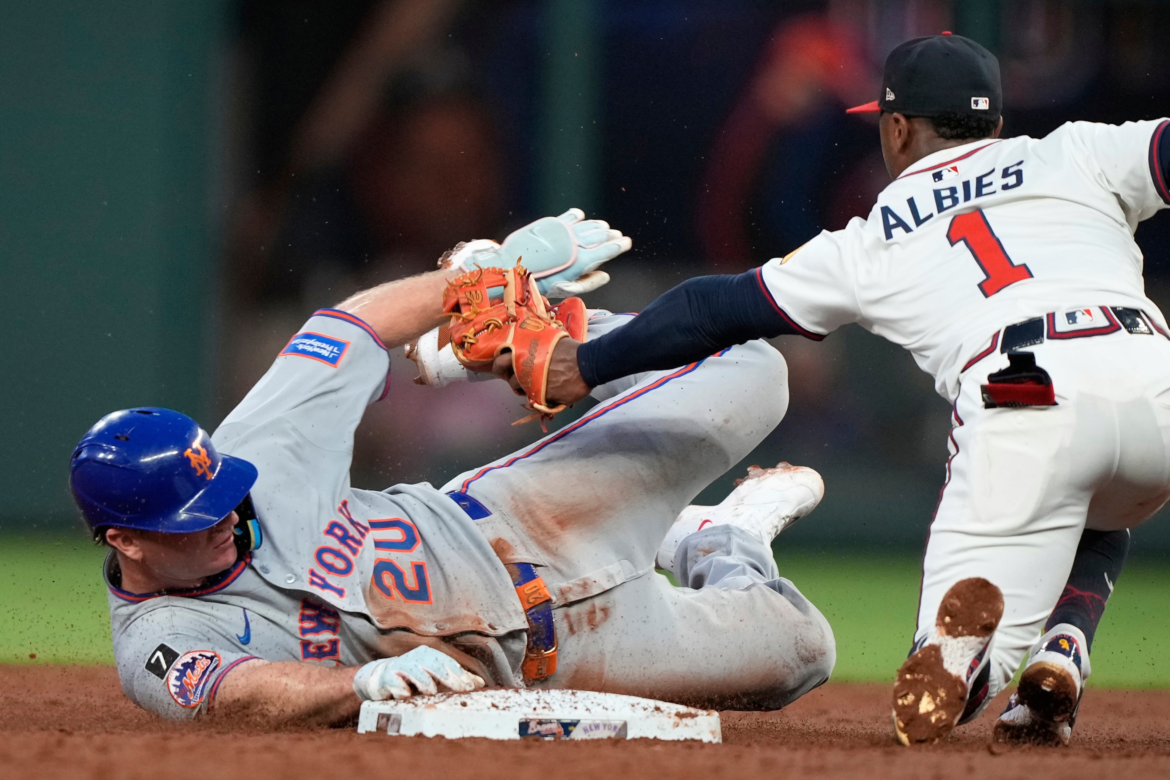 The Mets' Pete Alonso (left) slides into second base and is tagged out by Braves second baseman Ozzie Albies during the third inning on Tuesday, June 17, 2025, in Atlanta. (Brynn Anderson/AP)